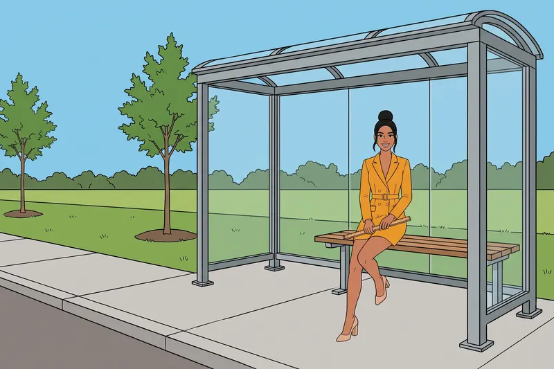 A woman waiting on a bench at a bus stop